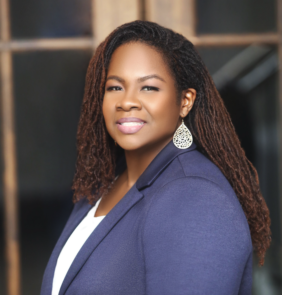 Headshot of Courtney pitts wearing a navy blazer and white top.