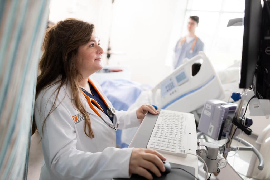 April Bryant, a clinical faculty with the College of Nursing, works with a student in a skils lab inside the nursing building in Research Park on March 26, 2024. Photo by Steven Bridges/University of Tennessee.