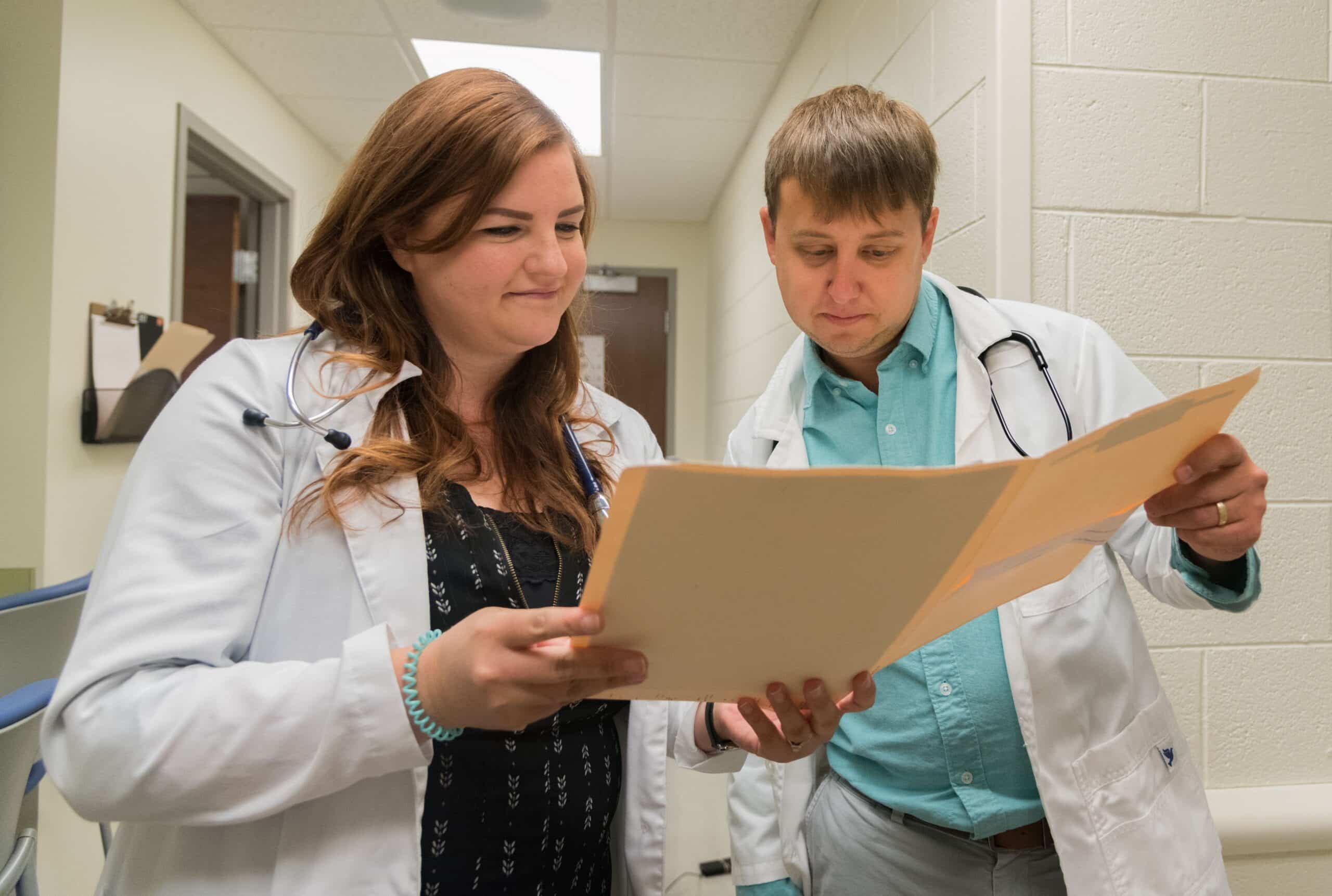 Grad students reviewing paperwork