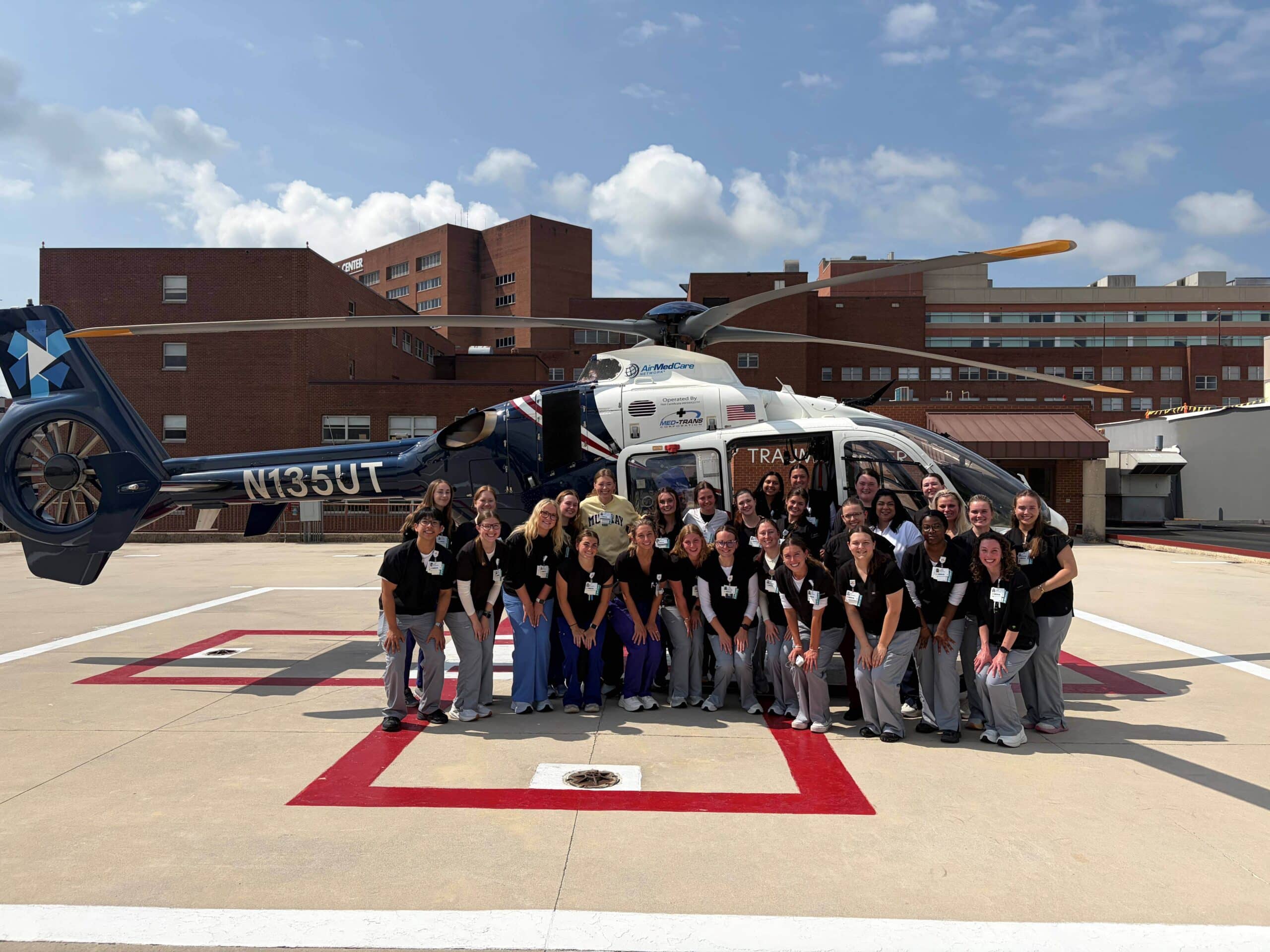 Group of nursing students in front of UTMC helicopter on landing pad